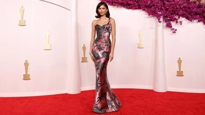 Zendaya without a doubt was the best-dressed celebrity of the Oscars night and made it to our top favourite list with her magnificent look in an Armani Prive gown. The actor and her stylist, Law Roach, never deliver a fashion miss, and this gown proves why she always wins the night with her sartorial prowess. The mauve pink one-shoulder gown came with a silver sequin embellished corset, sequin palm-patterned embellishments, and a figure-sculpting silhouette. Diamond jewels, a side-parted bob, feathered brows, caramel overlined lips, winged eyeliner, mascara on the lashes, and rouge on the cheeks completed the red carpet look. (Reuters) Zendaya without a doubt was the best-dressed celebrity of the Oscars night and made it to our top favourite list with her magnificent look in an Armani Prive gown. The actor and her stylist, Law Roach, never deliver a fashion miss, and this gown proves why she always wins the night with her sartorial prowess. The mauve pink one-shoulder gown came with a silver sequin embellished corset, sequin palm-patterned embellishments, and a figure-sculpting silhouette. Diamond jewels, a side-parted bob, feathered brows, caramel overlined lips, winged eyeliner, mascara on the lashes, and rouge on the cheeks completed the red carpet look. (Reuters)