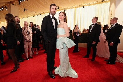 Emma Stone and Dave McCary pose on the red carpet during the Oscars arrivals at the 96th Academy Awards in Hollywood, Los Angeles, California. (REUTERS)