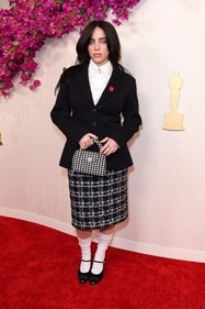 Billie Eilish in a white shirt layered with a Chanel tweed blazer and knee-length plaid tweed skirt (Photo: AFP) Billie Eilish in a white shirt layered with a Chanel tweed blazer and knee-length plaid tweed skirt (Photo: AFP)