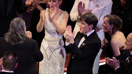 On the red carpet, Emily Blunt made her way over to greet Oppenheimer director Christopher Nolan and producer Emma Thomas.&nbsp;(REUTERS)