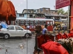Passing pedestrians and traffic are seen through the window of a leather goods stores in the Dharavi area of Mumbai.