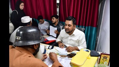 Advocate Nadeem Siddiqui helps people with their documents in Nagpada. (Bhushan Koyande/HT Photo)