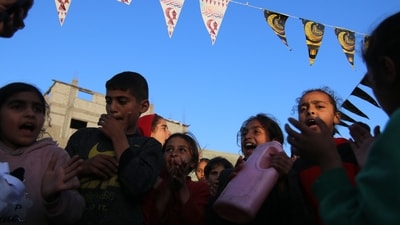 Displaced Palestinian children at a temporary camp during Ramadan west of Deir al-Balah, Gaza, (Bloomberg)