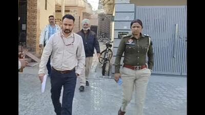 National Investigation Agency (NIA) officials along with Punjab Police personnel during a raid at Kotkapura in Faridkot district on Tuesday. (HT Photo) National Investigation Agency (NIA) officials along with Punjab Police personnel during a raid at Kotkapura in Faridkot district on Tuesday. (HT Photo)