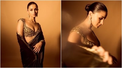 Coming to Alia's bespoke olive green velvet Manish Malhotra saree, the mesmerising number features scalloped borders embroidered with gold patti and sequin embellishments. She draped the six yards in traditional style, placing the pallu in a style that revealed the blouse and fell from her shoulder in a floor-sweeping length. (Instagram) Coming to Alia's bespoke olive green velvet Manish Malhotra saree, the mesmerising number features scalloped borders embroidered with gold patti and sequin embellishments. She draped the six yards in traditional style, placing the pallu in a style that revealed the blouse and fell from her shoulder in a floor-sweeping length. (Instagram)