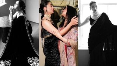 Alia styled the saree with a matching black velvet sleeveless blouse, a layered pearl choker necklace, matching pearl earrings adorned with a black stone, and high heels. Lastly, a messy top knot, darkened brows, ruby red lips, winged eyeliner, mascara on the lashes, and blushed cheeks completed the glam picks. (Instagram) Alia styled the saree with a matching black velvet sleeveless blouse, a layered pearl choker necklace, matching pearl earrings adorned with a black stone, and high heels. Lastly, a messy top knot, darkened brows, ruby red lips, winged eyeliner, mascara on the lashes, and blushed cheeks completed the glam picks. (Instagram)