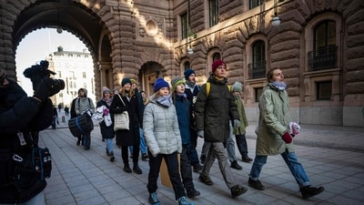 Swedish climate activist Greta Thunberg (C) and fellow activists make their way to block the main entrances of the Swedish Parliament during a protest due to the lack of action from the Swedish authorities, on March 11, 2024, in Stockholm, Sweden. ((Photo by Jonathan NACKSTRAND / AFP))