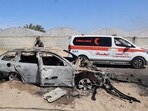 An ambulance drives past a car that was destroyed by Israeli bombardment in Rafah in the southern Gaza Strip. (AFP) An ambulance drives past a car that was destroyed by Israeli bombardment in Rafah in the southern Gaza Strip. (AFP)