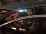 In the video, some unidentified women can be seen roughing up the BRS corporator sitting in the front seat of her car. In the video, some unidentified women can be seen roughing up the BRS corporator sitting in the front seat of her car.