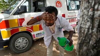 Jitendra Kumar, a paramedic who travels in ambulance, washes his face with water to cool himself off after dropping a patient at Lalitpur district hospital, in Banpur, in Indian state of Uttar Pradesh, June 17, 2023. (AP Photo/Rajesh Kumar Singh, File) (AP) Jitendra Kumar, a paramedic who travels in ambulance, washes his face with water to cool himself off after dropping a patient at Lalitpur district hospital, in Banpur, in Indian state of Uttar Pradesh, June 17, 2023. (AP Photo/Rajesh Kumar Singh, File) (AP)