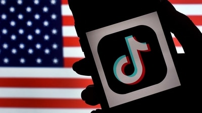 (FILES) In this photo illustration, the social media application logo, TikTok is displayed on the screen of an iPhone on an American flag background on August 3, 2020 in Arlington, Virginia. The US House of Representatives overwhelmingly approved a bill on March 13, 2024 that would force Tiktok to divest from its Chinese owner or get banned from the United States. (Photo by Olivier DOULIERY / AFP) (AFP) (FILES) In this photo illustration, the social media application logo, TikTok is displayed on the screen of an iPhone on an American flag background on August 3, 2020 in Arlington, Virginia. The US House of Representatives overwhelmingly approved a bill on March 13, 2024 that would force Tiktok to divest from its Chinese owner or get banned from the United States. (Photo by Olivier DOULIERY / AFP) (AFP)