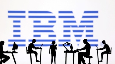 IBM layoffs: Figurines with computers and smartphones are seen in front of IBM logo. The company reportedly announced job cuts. (Reuters)