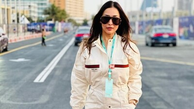 She paired the jumpsuit with oversized shades, a neon handbag, gold watch and dark brown boots. (Instagram) She paired the jumpsuit with oversized shades, a neon handbag, gold watch and dark brown boots. (Instagram)