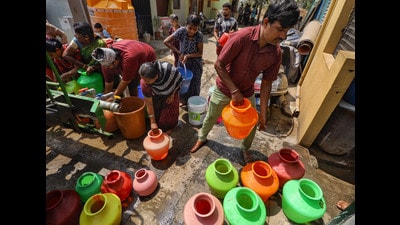 People collect free drinking water from a tanker. (PTI) People collect free drinking water from a tanker. (PTI)