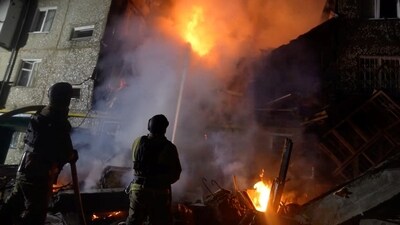 Rescuers work to extinguish fire at a building due to a drone attack. (REUTERS)