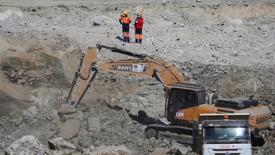 One of the trapped workers was freed and airlifted to hospital in "serious condition", police said.