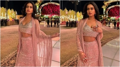 The Manish Malhotra lehenga features a sleeveless choli decked with shimmering silver gemstones, a plunging halter neckline, cropped hem length, and a backless design. She layered a chiffon dupatta decked in shimmering gemstones embellished with striped lines on her shoulders to beautify the look further. (Instagram) The Manish Malhotra lehenga features a sleeveless choli decked with shimmering silver gemstones, a plunging halter neckline, cropped hem length, and a backless design. She layered a chiffon dupatta decked in shimmering gemstones embellished with striped lines on her shoulders to beautify the look further. (Instagram)