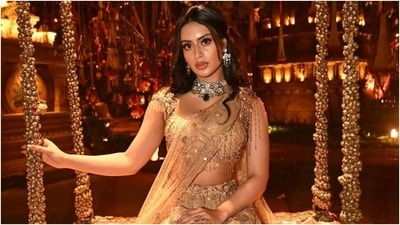 The ensemble comes in a pleasant beige shade and features a short choli, lehenga, and a dupatta. While the blouse has beaded tassel embellishments, a wide neckline, and a fitted bust, the skirt features an A-line silhouette, floral sequin embroidery, a sheer overlay, and a layered ghera. Lastly, she draped a net dupatta on the shoulder to complete the look. (Instagram) The ensemble comes in a pleasant beige shade and features a short choli, lehenga, and a dupatta. While the blouse has beaded tassel embellishments, a wide neckline, and a fitted bust, the skirt features an A-line silhouette, floral sequin embroidery, a sheer overlay, and a layered ghera. Lastly, she draped a net dupatta on the shoulder to complete the look. (Instagram)