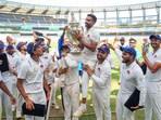 Mumbai's Dhawal Kulkarni lifts the championship trophy after winning the Ranji Trophy final Mumbai's Dhawal Kulkarni lifts the championship trophy after winning the Ranji Trophy final