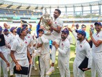 Mumbai's Dhawal Kulkarni lifts the championship trophy Mumbai's Dhawal Kulkarni lifts the championship trophy