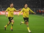 Borussia Dortmund's English midfielder Jadon Sancho (R) celebrates after scoring the opening 1-0 goal.