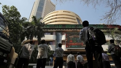 Stock market crash: People look at a screen displaying the Sensex results on the facade of the Bombay Stock Exchange (BSE) building in Mumbai. (Reuters)