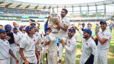 Mumbai's Dhawal Kulkarni lifts the championship trophy after winning the Ranji Trophy final (PTI) Mumbai's Dhawal Kulkarni lifts the championship trophy after winning the Ranji Trophy final (PTI)