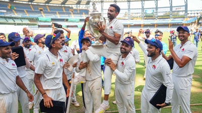 Mumbai's Dhawal Kulkarni lifts the championship trophy (PTI) Mumbai's Dhawal Kulkarni lifts the championship trophy (PTI)