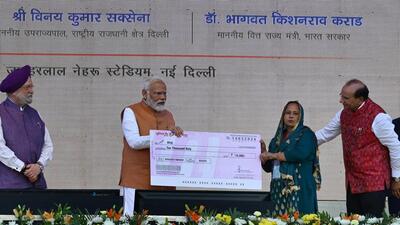Prime Minister Narendra Modi hands over a cheque to a beneficiary of SVANidhi scheme. (Arvind Yadav/HT) Prime Minister Narendra Modi hands over a cheque to a beneficiary of SVANidhi scheme. (Arvind Yadav/HT)
