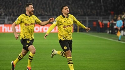 Borussia Dortmund's English midfielder Jadon Sancho (R) celebrates after scoring the opening 1-0 goal. (AFP)