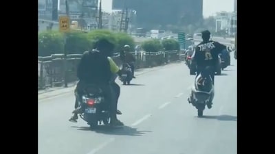 Man performing wheelie on a two-wheeler in Bengaluru. (X/@3rdEyeDude) Man performing wheelie on a two-wheeler in Bengaluru. (X/@3rdEyeDude)