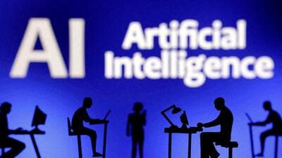 : Figurines with computers and smartphones are seen in front of the words "Artificial Intelligence AI" (REUTERS FILE PHOTO)