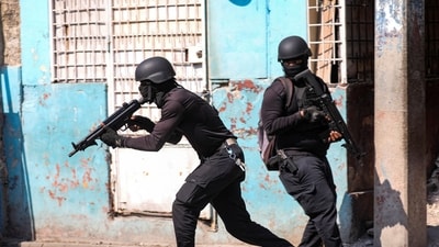 Police officers take part in an operation on the surroundings of the National Penitentiary following a fire, as a powerful gang leader in Haiti. (Reuters)