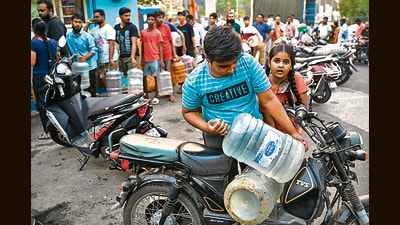 People wait in a queue with cans to collect drinking water amid an ongoing water crisis in Bengaluru. (AFP) People wait in a queue with cans to collect drinking water amid an ongoing water crisis in Bengaluru. (AFP)