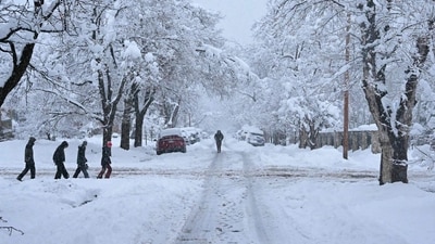 People walk during a snowstorm in Boulder, Colorado. The National Weather Service predicts as much as two feet of snow in the front range region of the state. Travel chaos in Colorado amid heavy snowstorm: Travellers stranded as highway shutdown, flights cancelled (Photo by Mark Makela/Getty Images via AFP) People walk during a snowstorm in Boulder, Colorado. The National Weather Service predicts as much as two feet of snow in the front range region of the state. Travel chaos in Colorado amid heavy snowstorm: Travellers stranded as highway shutdown, flights cancelled (Photo by Mark Makela/Getty Images via AFP)