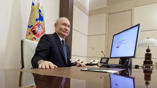 In this pool photograph distributed by Russia's state agency Sputnik, Russian President Vladimir Putin votes online in the presidential election at the Novo-Ogaryovo state residence, outside Moscow, (AFP)
