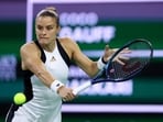 Maria Sakkari plays a backhand against Coco Gauff.