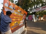 Workers remove political banners after the Model Code of Conduct was enforced following the announcement of the schedule of Lok Sabha elections, in Lucknow, Workers remove political banners after the Model Code of Conduct was enforced following the announcement of the schedule of Lok Sabha elections, in Lucknow,
