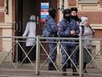 Russian Rosguardia (National Guard) servicemen stand guard at a pooling station during the presidential elections
