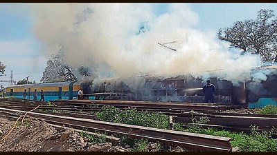 Firefighters dousing flames in the train coach stationed at Ambala City railway station. (HT Photo)