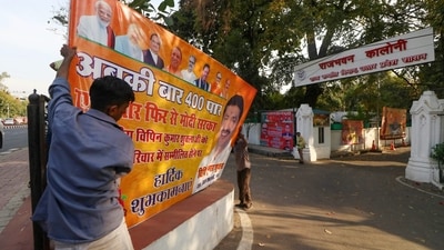 Workers remove political banners after the Model Code of Conduct was enforced following the announcement of the schedule of Lok Sabha elections, in Lucknow, (PTI) Workers remove political banners after the Model Code of Conduct was enforced following the announcement of the schedule of Lok Sabha elections, in Lucknow, (PTI)