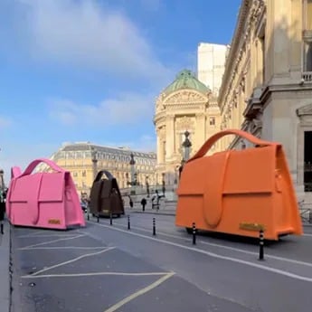 Brightly coloured Jacquemus handbags zipped through the streets of Paris, in a surrealist online ad campaign last year. Brightly coloured Jacquemus handbags zipped through the streets of Paris, in a surrealist online ad campaign last year.