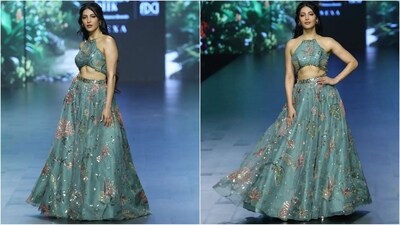 Shruti Hasan stuns as showstopper for designer Sakshi Bhati. Her mesmerising look featured a halter neck crop top in an enchanting cyan colour. The intricate floral pattern that adorned her outfit added a touch of sartorial flair and made her outfit a complete showstopper. With a matching skirt, hoop earrings, bold lips and loose hair, she oozed elegance and glamour. (Instagram/@lakmefashionwk) Shruti Hasan stuns as showstopper for designer Sakshi Bhati. Her mesmerising look featured a halter neck crop top in an enchanting cyan colour. The intricate floral pattern that adorned her outfit added a touch of sartorial flair and made her outfit a complete showstopper. With a matching skirt, hoop earrings, bold lips and loose hair, she oozed elegance and glamour. (Instagram/@lakmefashionwk)