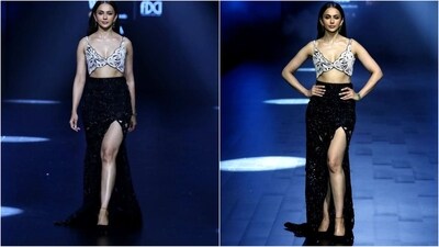 Newly-wed Rakul Preet Singh hit the ramp with her exquisite look. The diva showcased designer Ritika Mirchandani's collection and her showstopper look was definitely swoon-worthy. She wore a silver plunging v-neck bralette with a black thigh-high slit skirt. She finished off the look with nude lips, smoky eyes and loose hair. (Instagram/@lakmefashionwk) Newly-wed Rakul Preet Singh hit the ramp with her exquisite look. The diva showcased designer Ritika Mirchandani's collection and her showstopper look was definitely swoon-worthy. She wore a silver plunging v-neck bralette with a black thigh-high slit skirt. She finished off the look with nude lips, smoky eyes and loose hair. (Instagram/@lakmefashionwk)