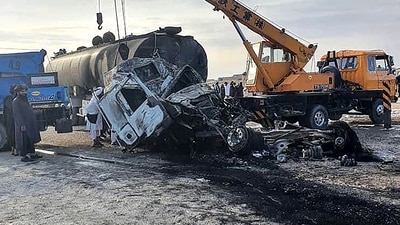 Security personnel and volunteers standing near the wreckage of burned passenger bus and oil tanker after they and a motorbike collided on the Herat-Kandahar highway in Grishk district of Helmand province (AFP) Security personnel and volunteers standing near the wreckage of burned passenger bus and oil tanker after they and a motorbike collided on the Herat-Kandahar highway in Grishk district of Helmand province (AFP)