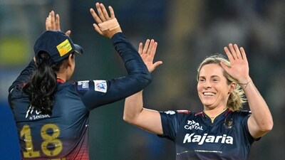 Royal Challengers Bangalore's Sophie Molineux (R) celebrates with captain Smriti Mandhana (L) after taking the wicket of Delhi Capitals' Shafali Verma (AFP)