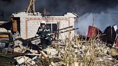 A rescuer works at a site of a residential building damaged during a Russian drone strike (via REUTERS)