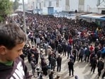 Palestinians gather to receive aid outside an UNRWA warehouse as Gaza residents face crisis levels of hunger, amid the ongoing conflict between Israel and Hamas,