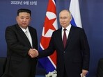 Russian President Vladimir Putin, right, and North Korean leader Kim Jong Un shake hands 