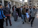 Palestinians carry away the body of a man killed in Israeli bombardment from the morgue of the Al-Shifa hospital in Gaza City 